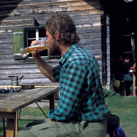 hiker drinking a beer infront of a alpine hut, Karwendel Mountains, Austria